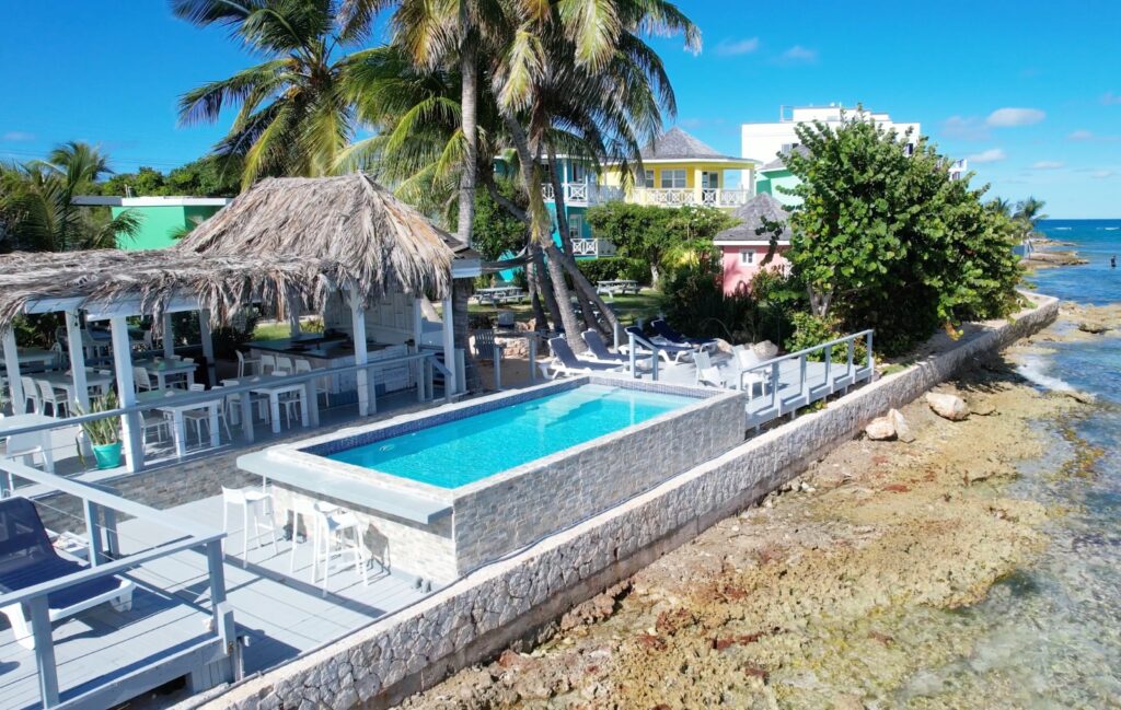 91f938d9-d7de-49ba-a3cb-fff8fc30d656 Infinity pool and lounge area at Arawak Beach Club, Anguilla beachfront hotel