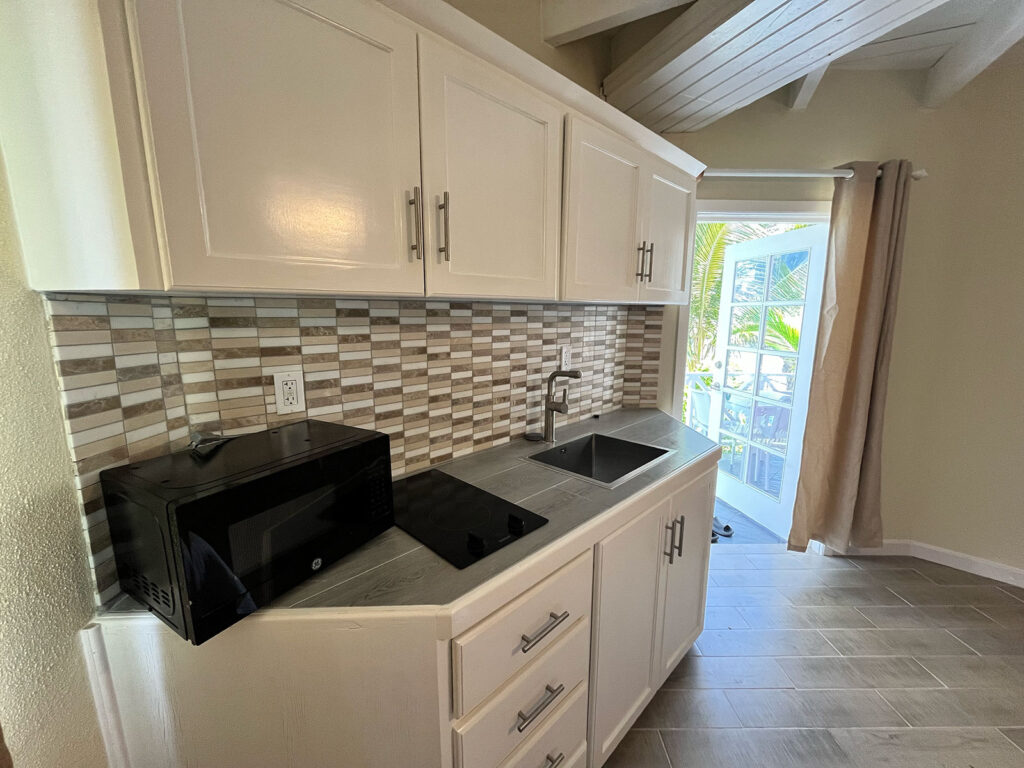 Arawak_suite-1-2_1600 Full kitchen with farmhouse sink and cabinetry at Arawak Beach Club suite, Anguilla