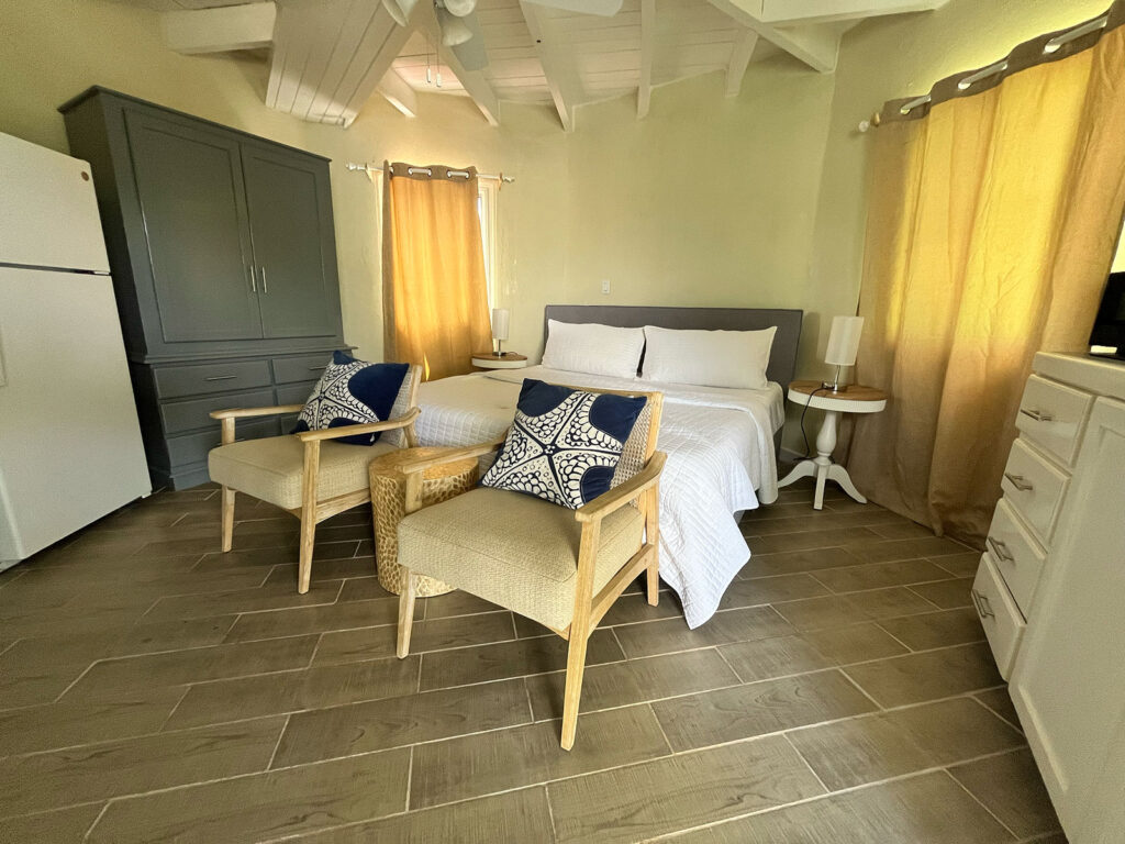 Arawak_suite-1-7_1600 Bedroom and dining area with natural light inside Ocean Pearl suite at Arawak Beach Club, Anguilla