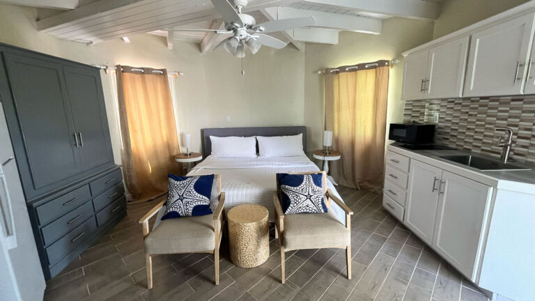 King bed and sitting area with natural light in Ocean Pearl suite at Arawak Beach Club, Anguilla