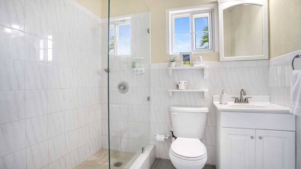 Arawak_suite-10-4_1600 Bathroom with glass walk-in shower and vanity in the Starfish Suite at Arawak Beach Club in Anguilla