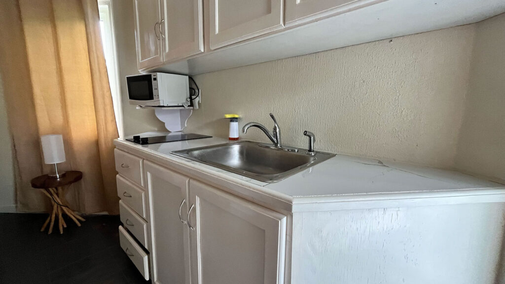 Arawak_suite-2-3_1600 Compact kitchenette with sink and microwave in the Pelican Suite at Arawak Beach Club in Anguilla