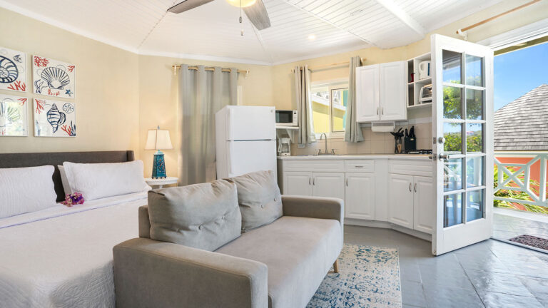 Open-concept layout with sofa, kitchenette, and ceiling fan in the Blue Horizon Suite at Arawak Beach Club in Anguilla