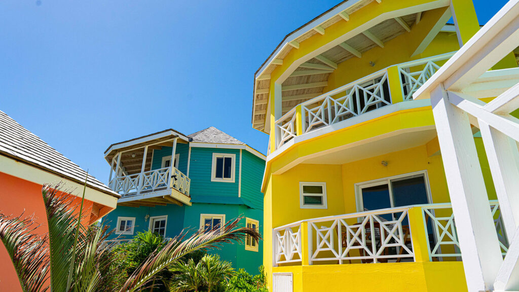Arawak_suite-6-11_1600 Colorful buildings at Arawak Beach Club in Anguilla, featuring private balconies and tropical architecture