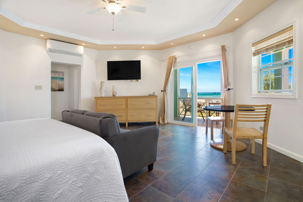 Arawak_suite-8-1_1600 Ocean view from bed with sofa and balcony doors in the Sea Mist Suite at Arawak Beach Club in Anguilla