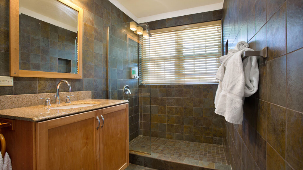 Arawak_suite-8-3_1600 Bathroom with walk-in shower and vanity in the Sea Mist Suite at Arawak Beach Club in Anguilla