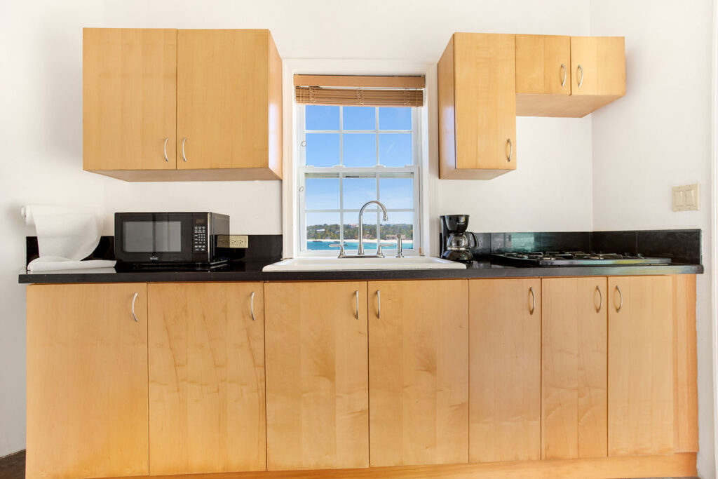 Arawak_suite-8-4_1600 Kitchenette with light wood cabinetry and microwave in the Sea Mist Suite at Arawak Beach Club in Anguilla