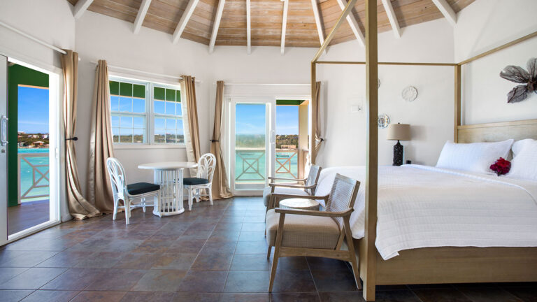 Open suite layout with king bed and balcony access in the Sea View Suite at Arawak Beach Club in Anguilla